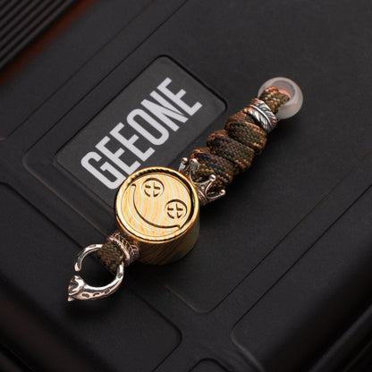 EDC Lanyard Bead – Bad Guy Smile | Titanium Zirconium Damascus Mokuti Super Conductor