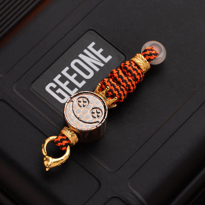 EDC Lanyard Bead – Bad Guy Smile | Titanium Zirconium Damascus Mokuti Super Conductor