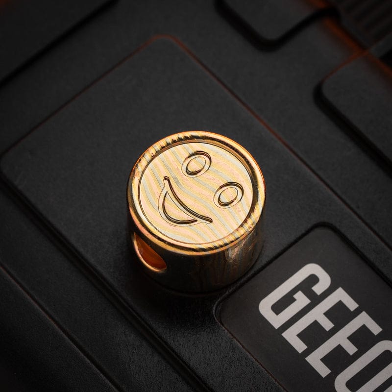 EDC Lanyard Bead – Bad Guy Smile | Titanium Zirconium Damascus Mokuti Super Conductor